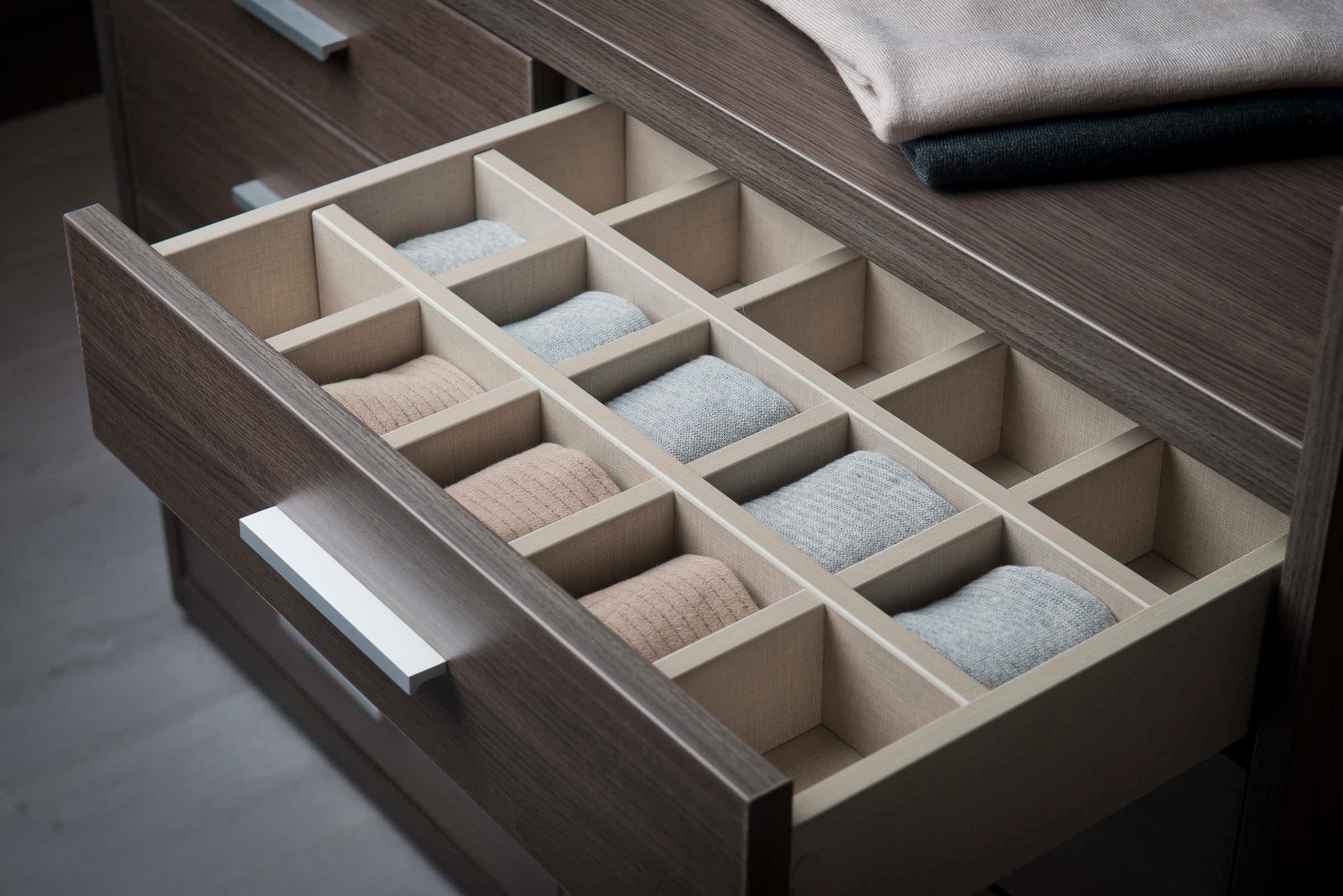 Wardrobe drawer with fitted dividers holding rolled socks