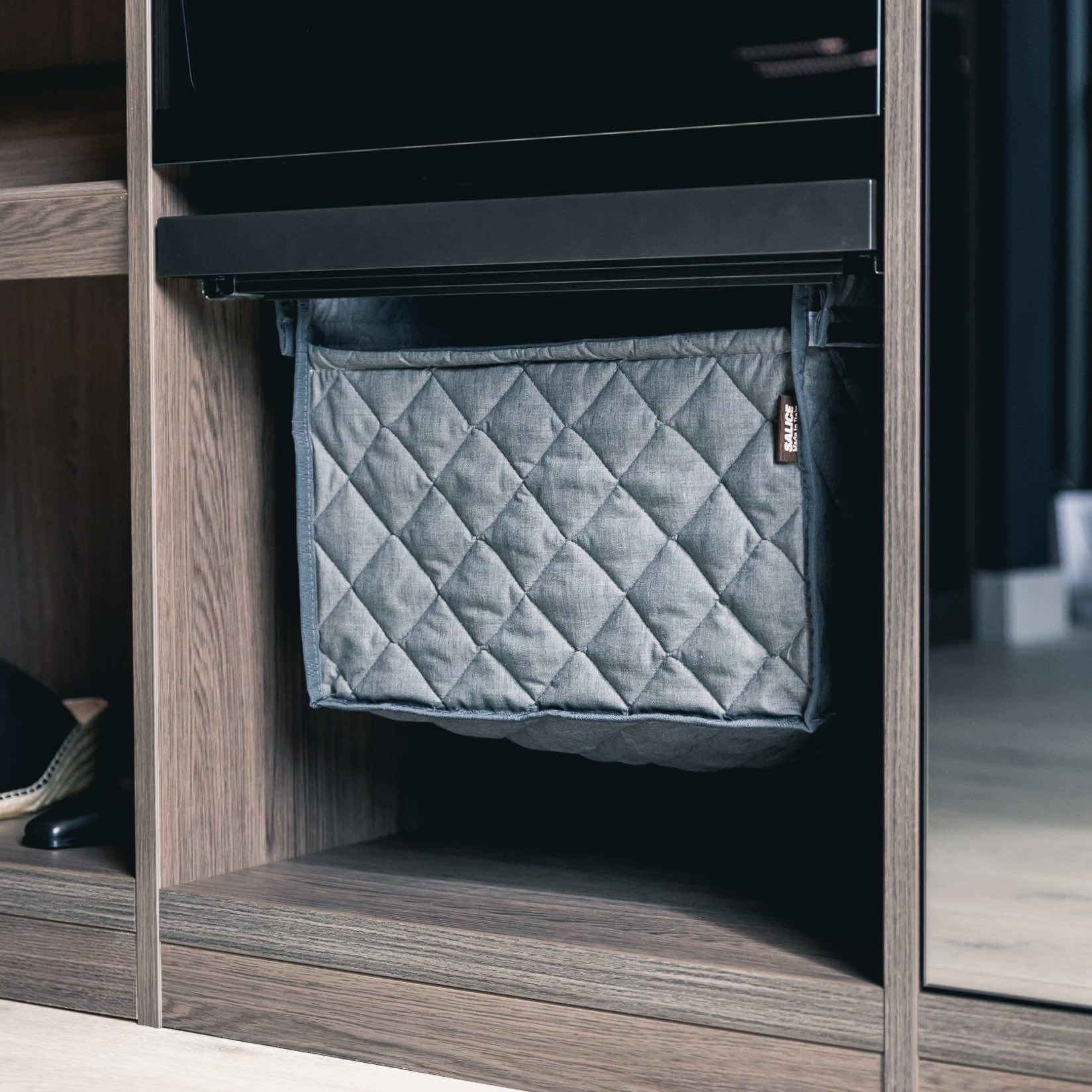 Pull-out quilted laundry basket fitted inside a wardrobe