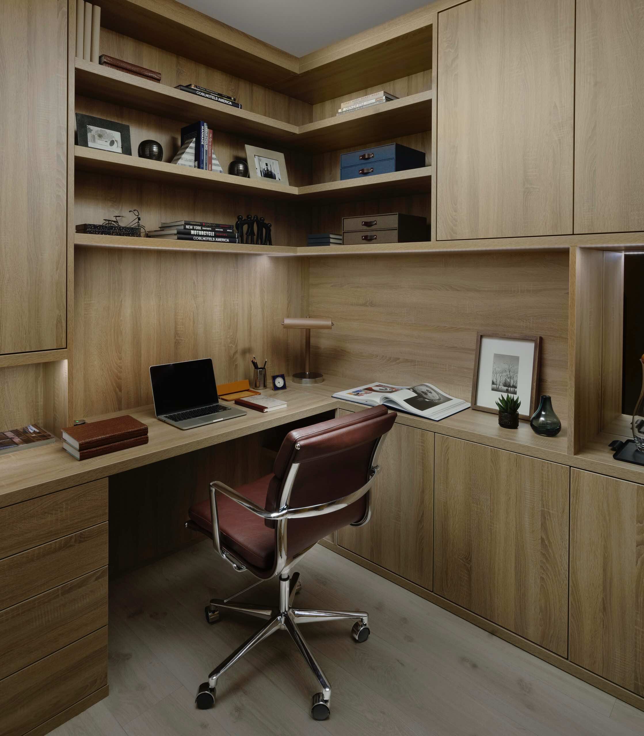 Shadow Oak corner study with fitted desk, shelving and cupboards and a leather chair