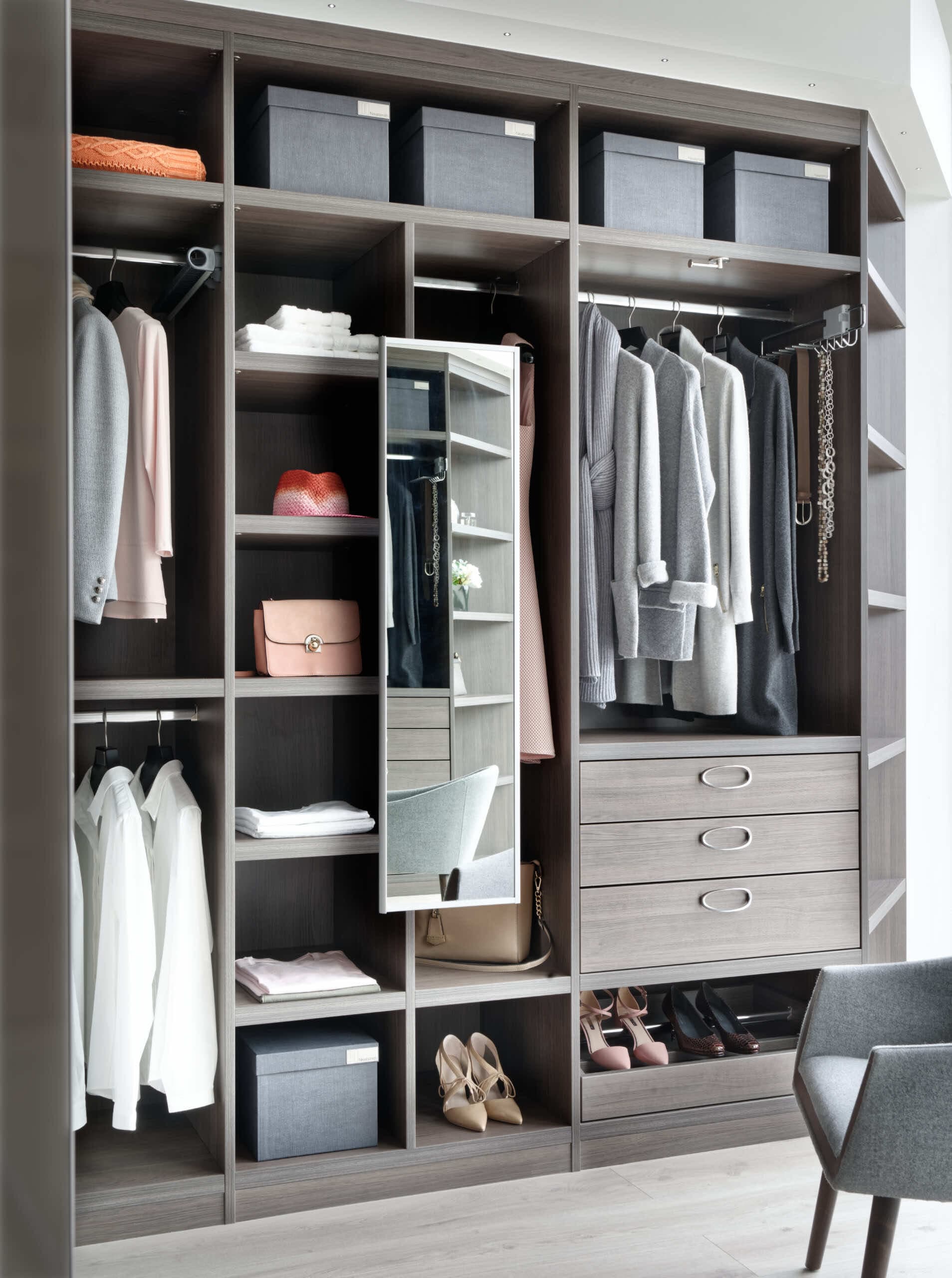 Fitted wardrobe in grey oak with hanging space, drawers and a swivel mirror