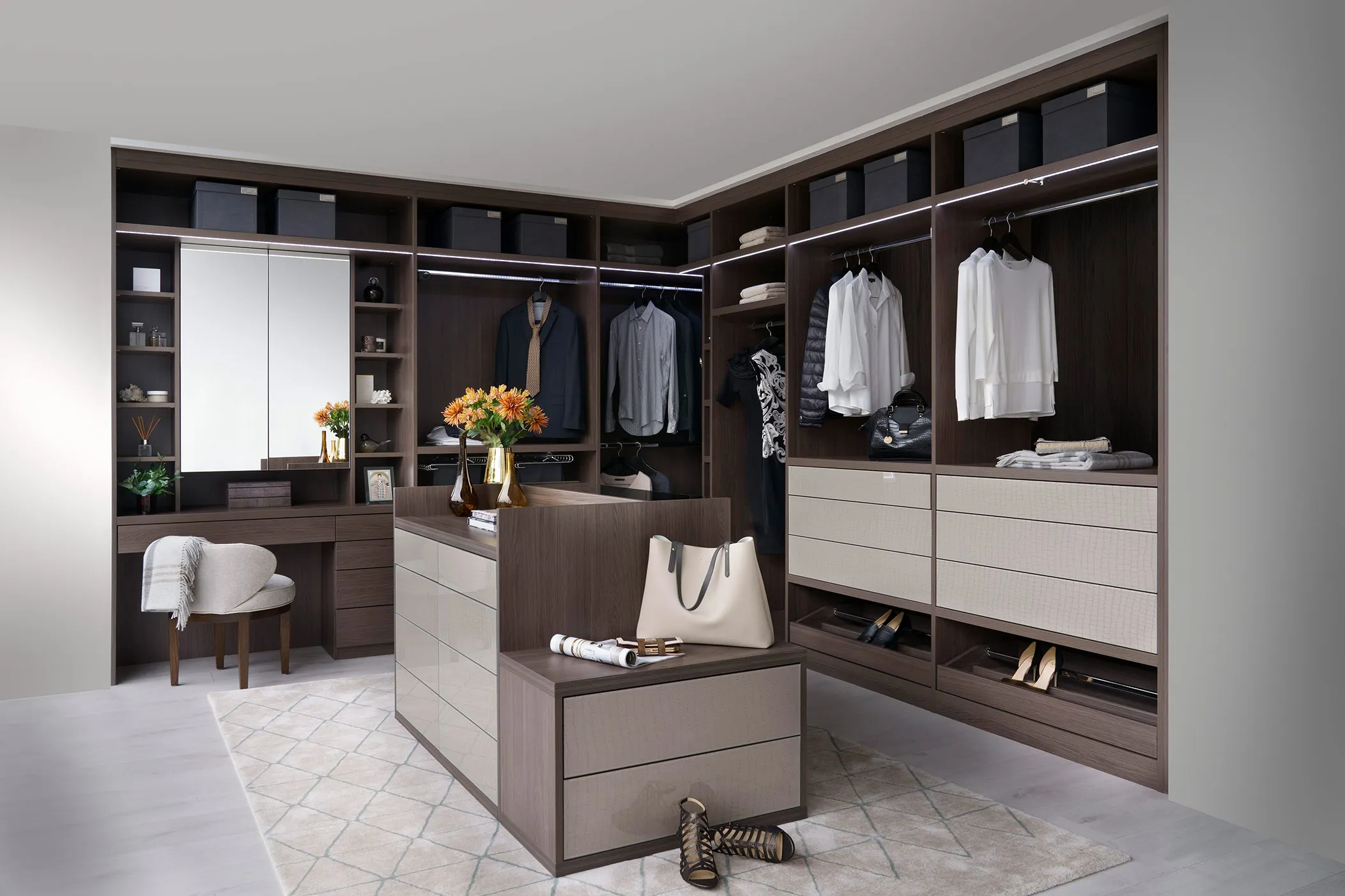 Corner dressing room in dark oak with island unit, hanging rails and dressing table