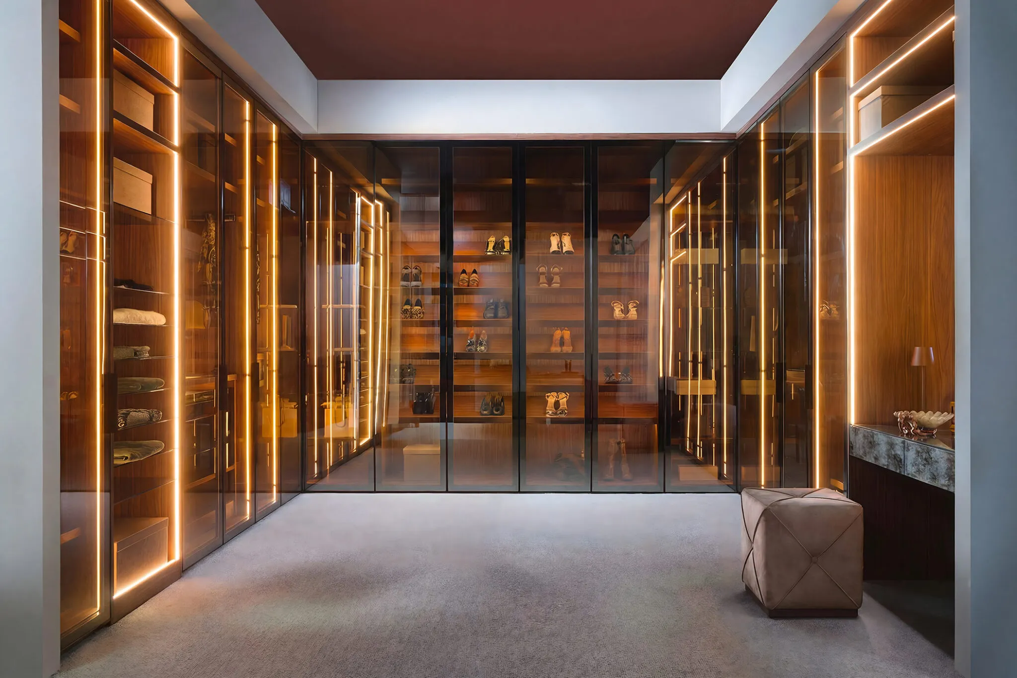 Dressing room with smoked glass wardrobe doors lit by vertical LED strips