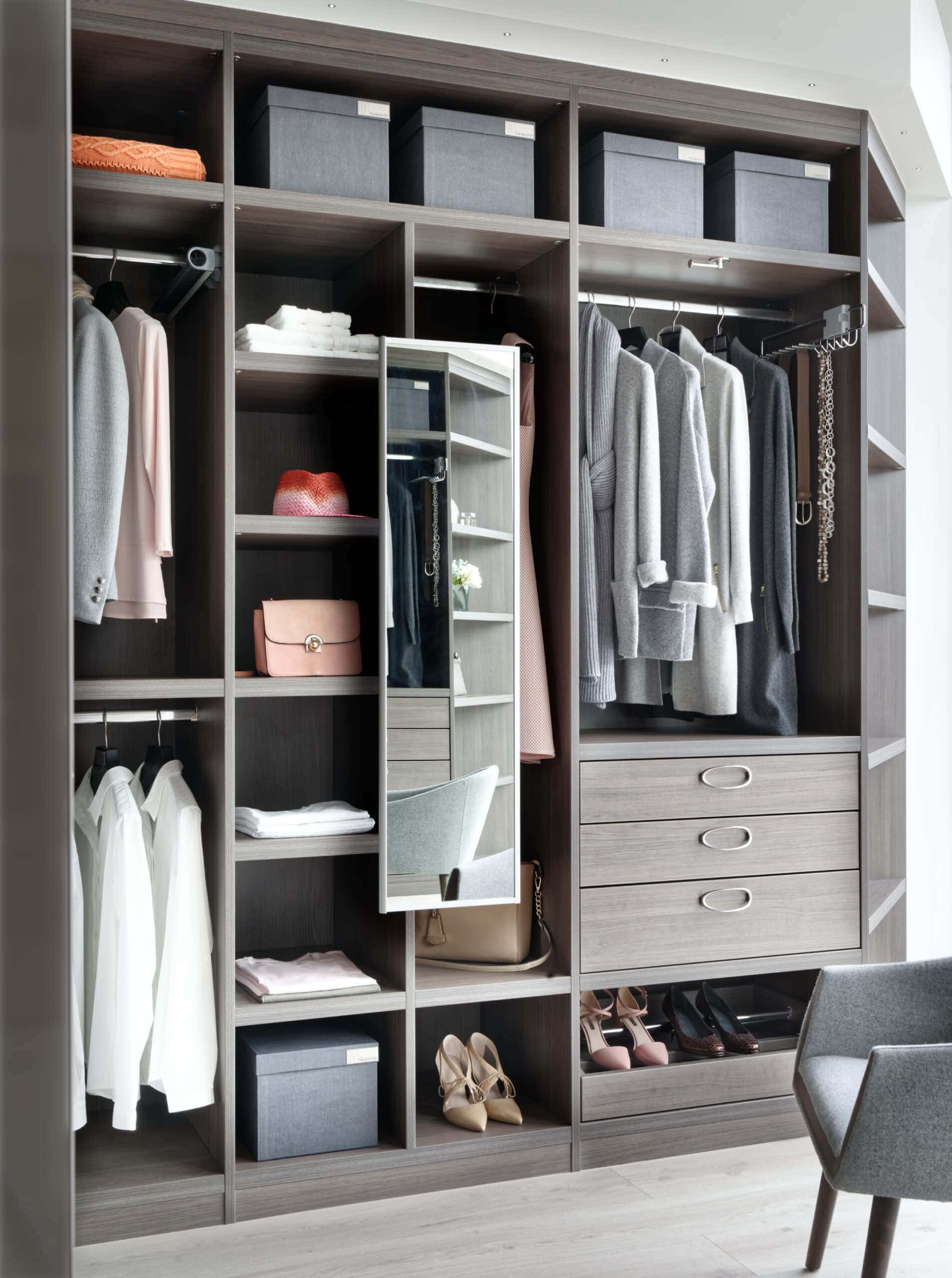 Fitted wardrobe in grey oak with hanging space, drawers and a swivel mirror