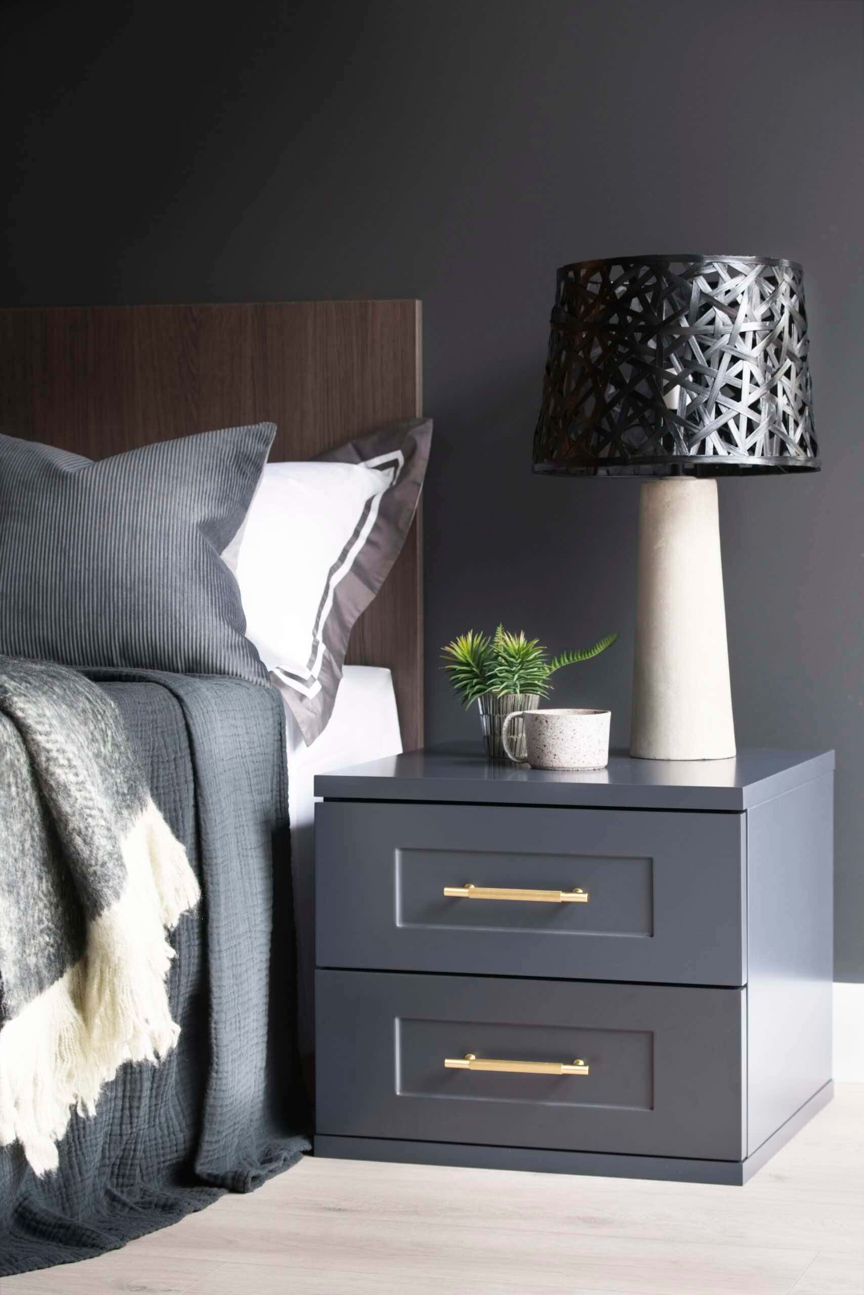 Bedside table in dark matt lacquer with Shaker drawers and brushed brass handles