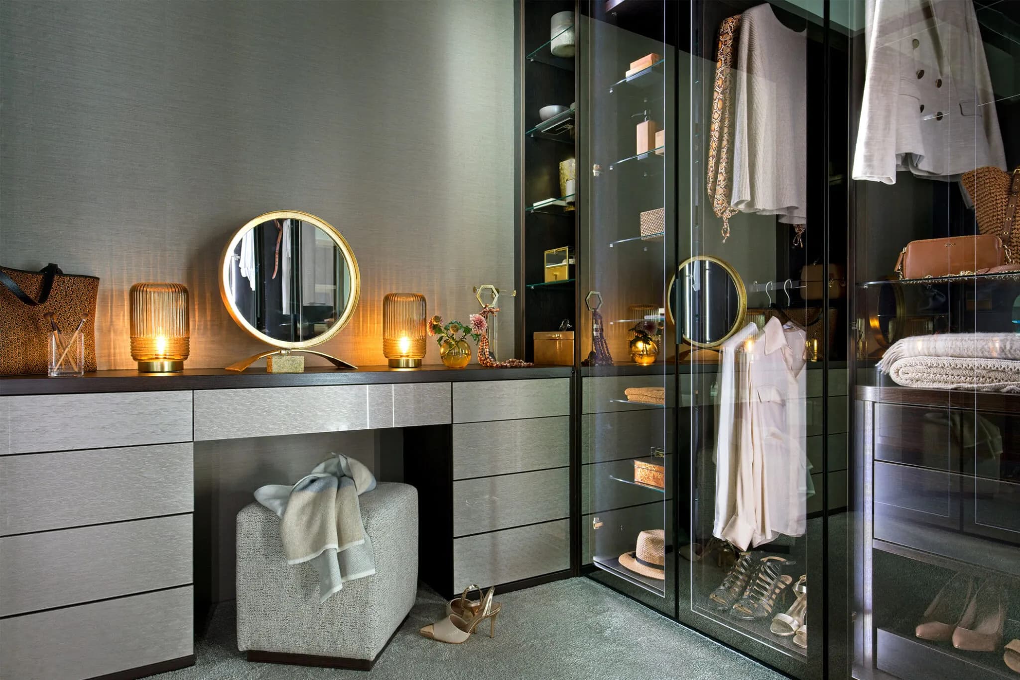 Corner walk-in wardrobe with bronze glass doors, LED-lit shelves and drawers