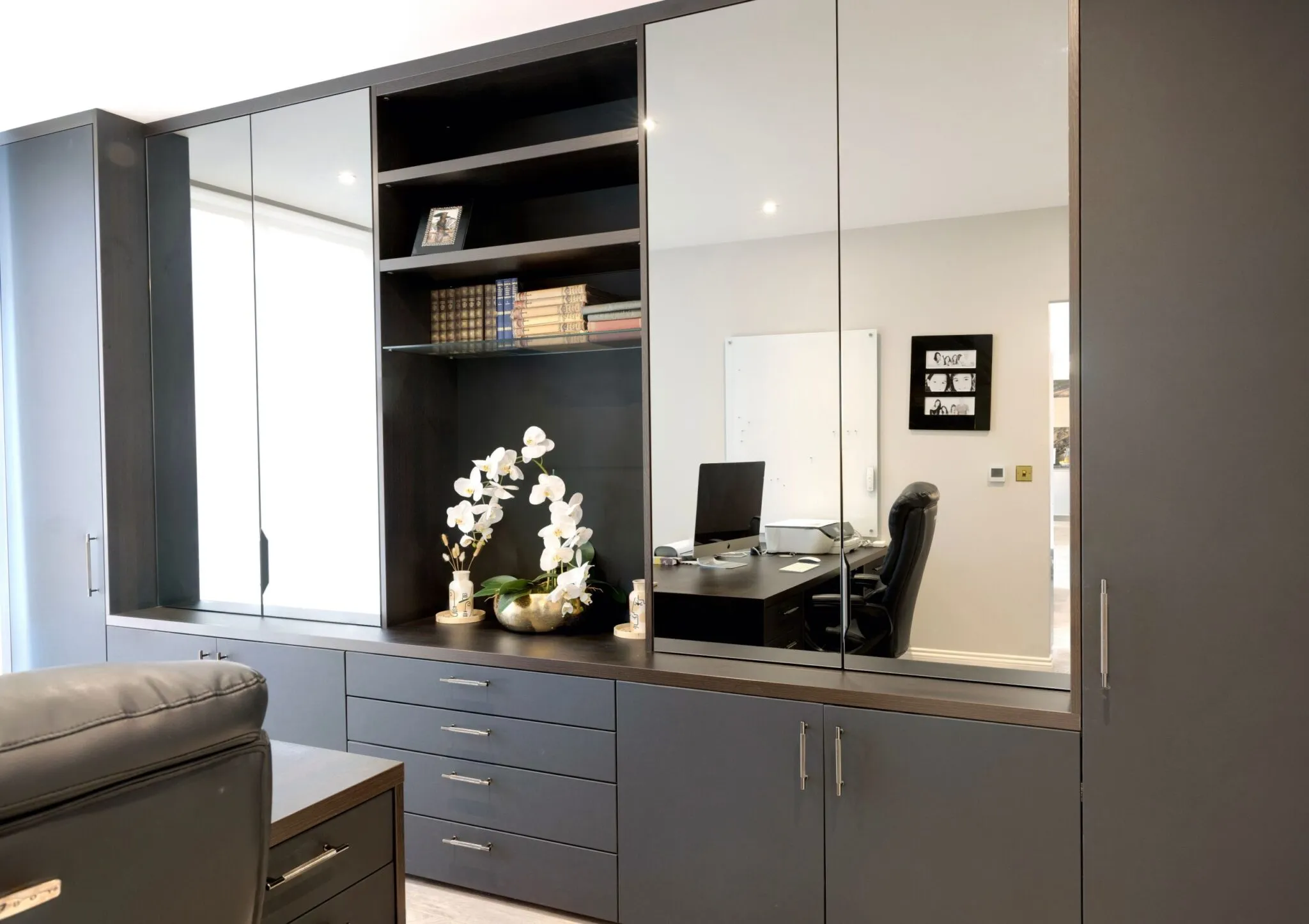 Study with grey fitted cabinets, mirrored doors, drawers and a built-in desk
