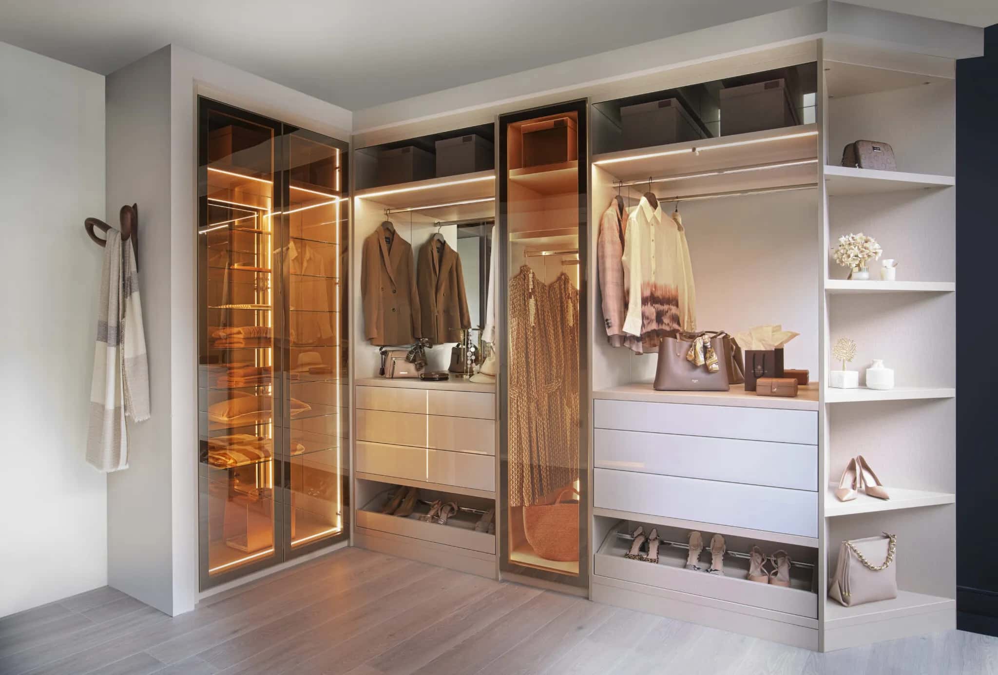 Walk-in wardrobe with reflex glass doors, LED lighting, drawers, open shelving and hanging rails