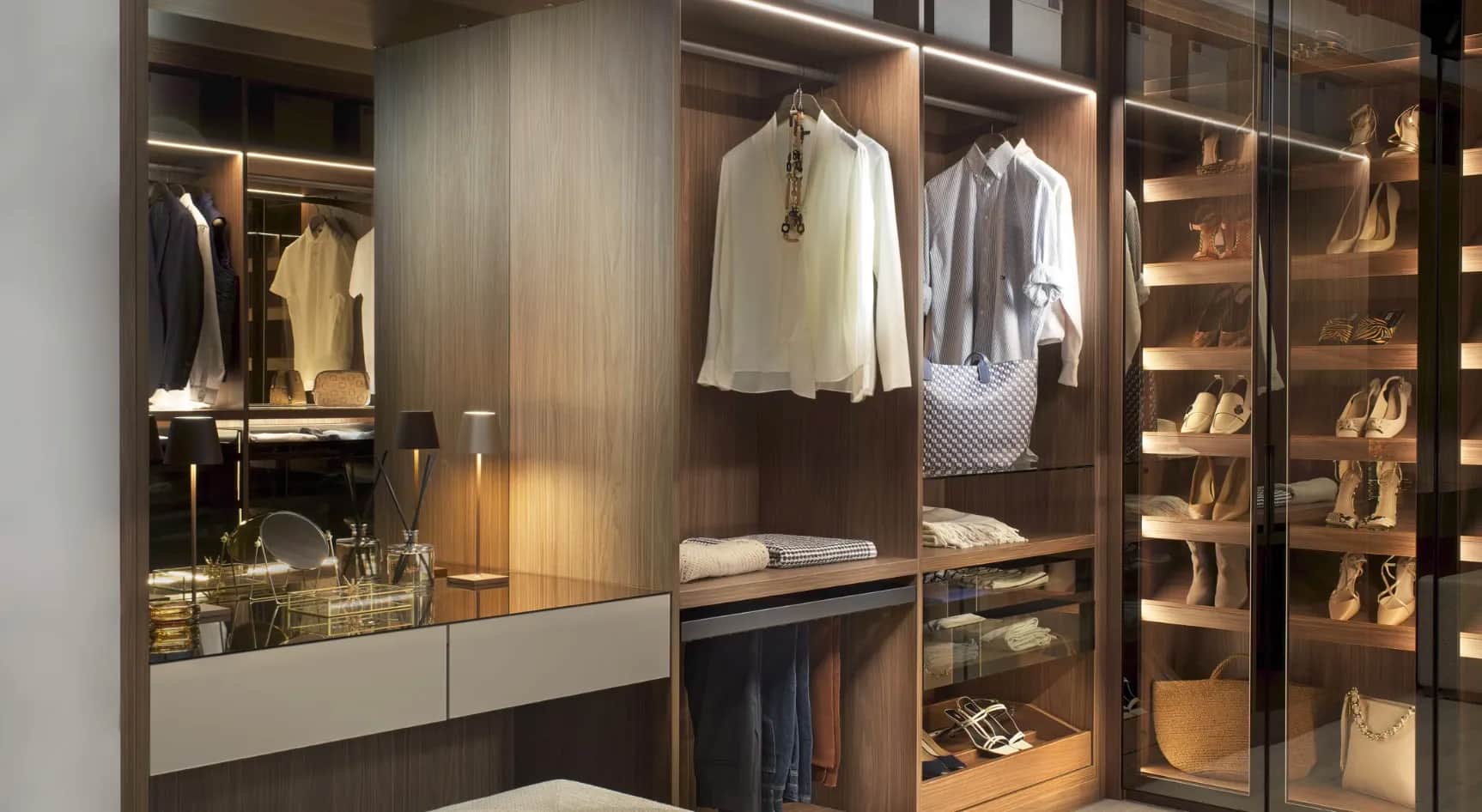 Walk-in wardrobe with hanging shirts, mirrored panel, shoe shelves and glass doors