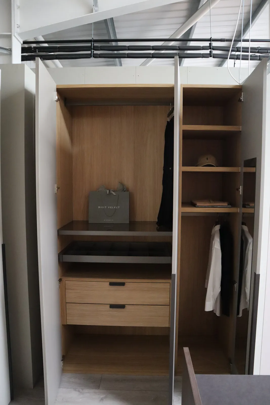 Open wardrobe with oak interior, drawers, jewellery tray and hanging clothes