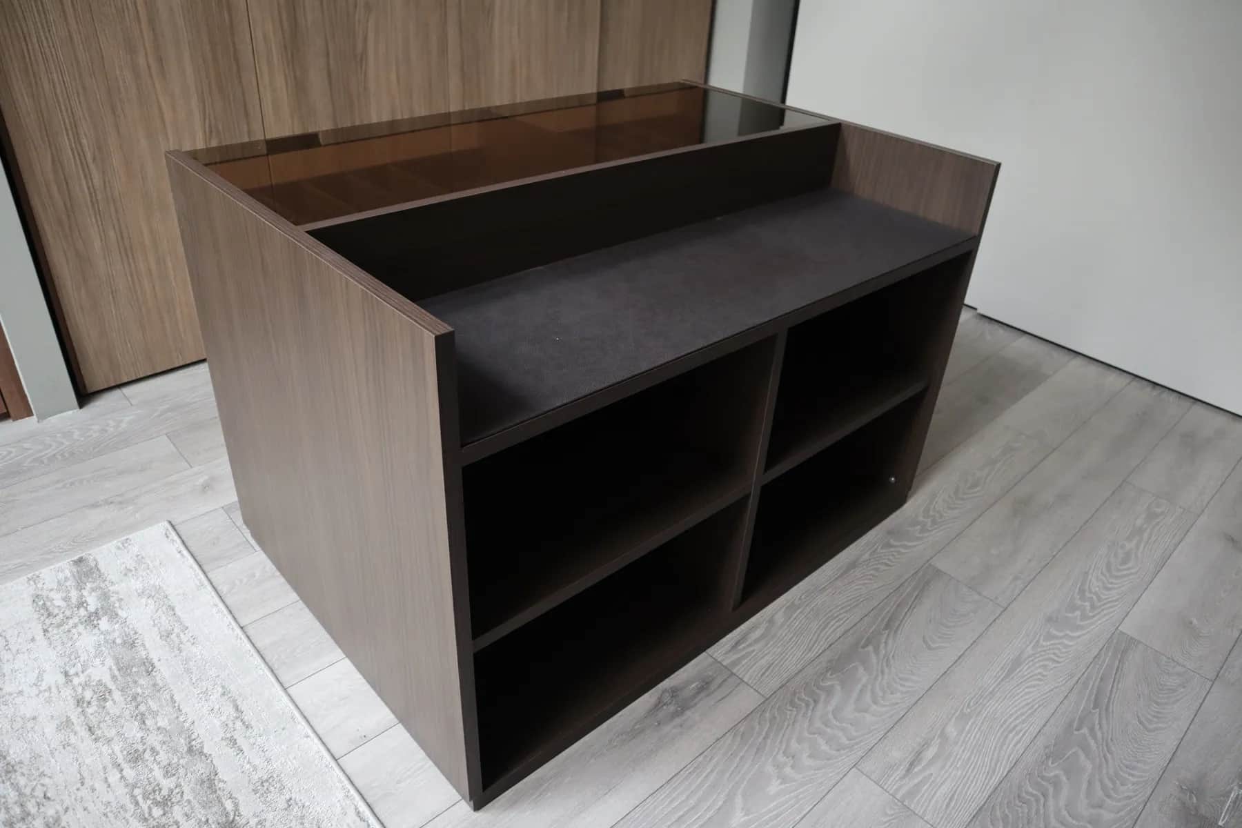 Walnut dressing island unit with open shelving and dark glass top