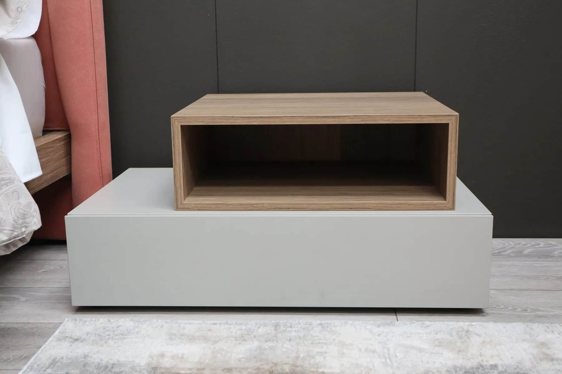 Low grey bedside unit topped with a walnut open shelf box