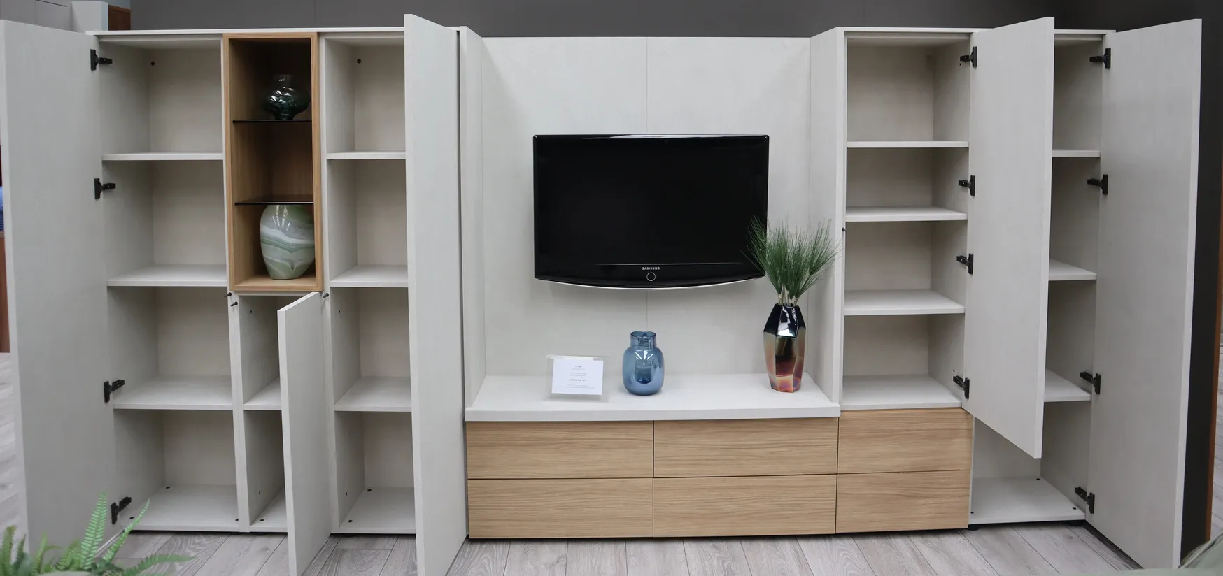 Living room TV unit with open cupboard doors, shelving and oak drawers