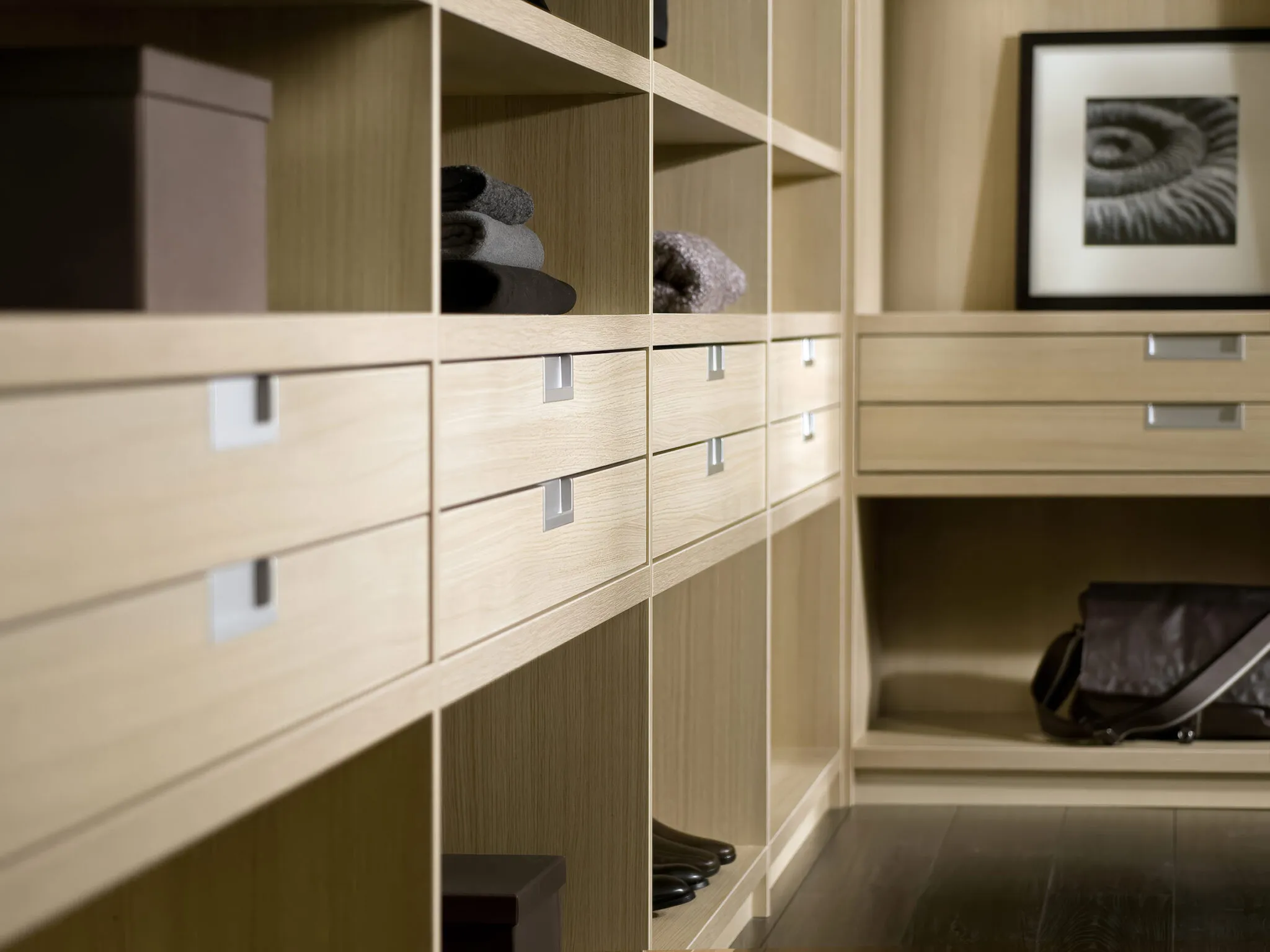 Light oak walk-in wardrobe drawers and shelving with recessed handles
