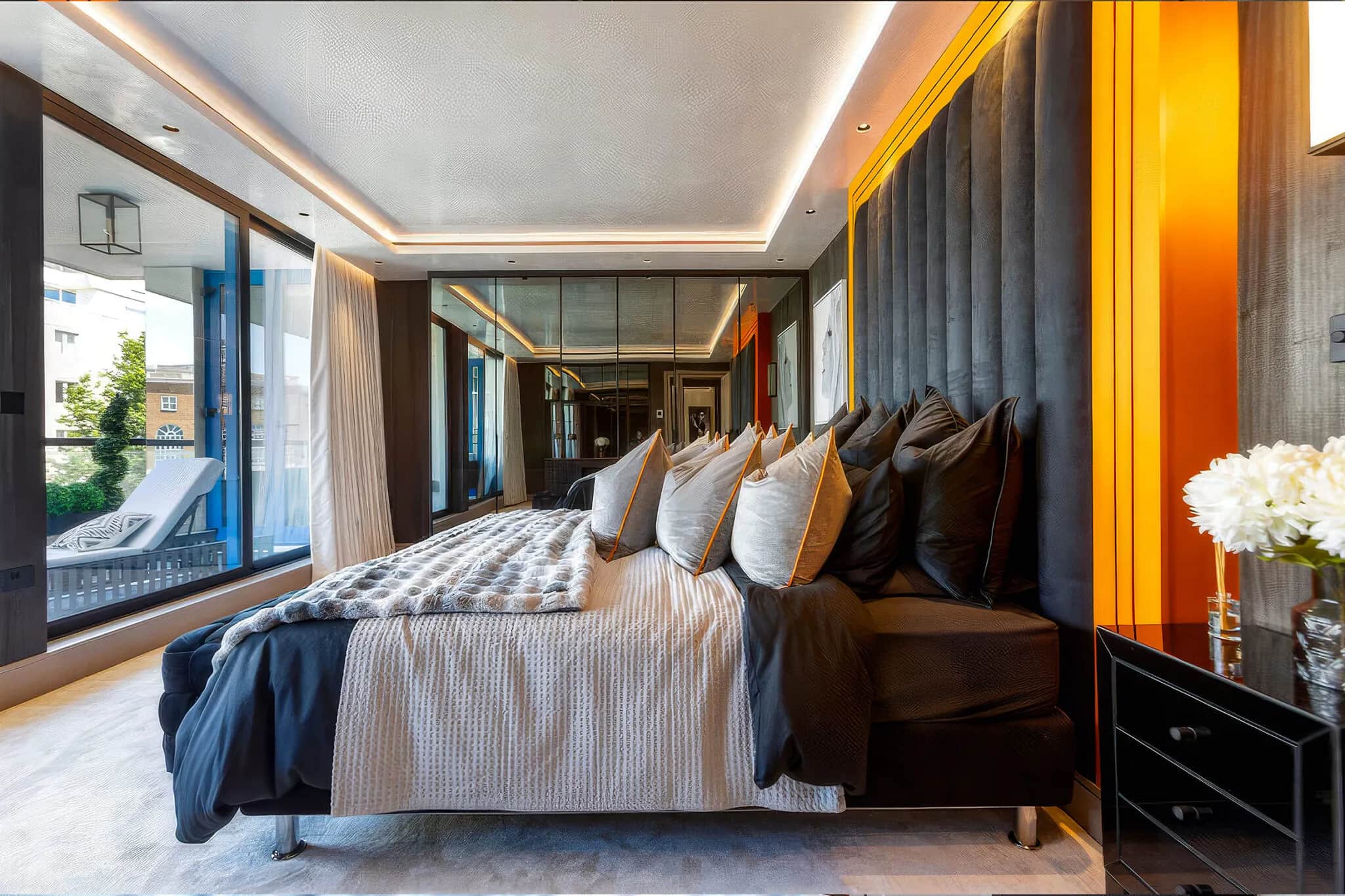 Penthouse bedroom with LED cove lighting, padded headboard and balcony glazing