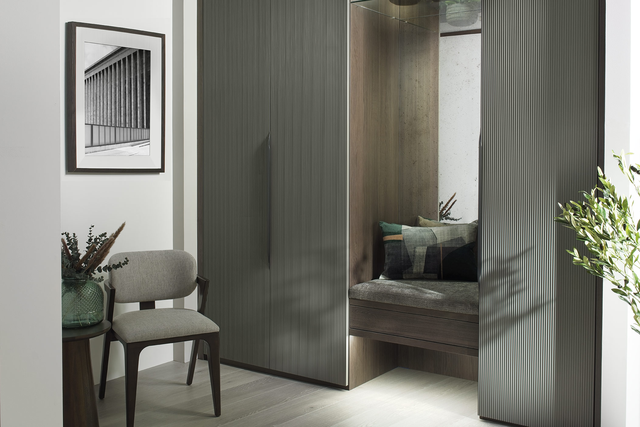 fitted wardrobes with inset seating and chair.